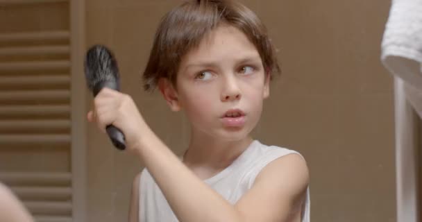 Boy Combs His Hair Mirror Holds Comb His Hand Makes — Vídeos de Stock