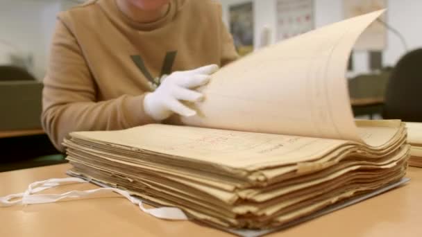 白い手袋で国立公文書館の従業員の手 ドキュメンタリーの情報を検索します 古い秘密のアーカイブ文書のスタックのクローズアップ 2023チョドフ プラハ — ストック動画