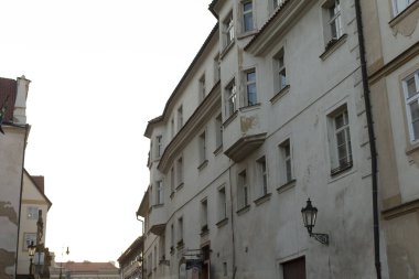 A beautifully maintained aged building stands proudly in a narrow street, showcasing intricate features typical of historic areas, evoking charm and nostalgia for the past clipart