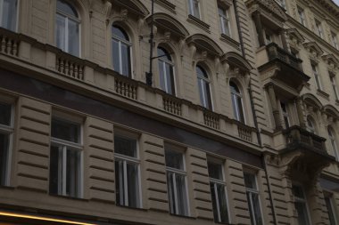 This view showcases a historical buildings facade, featuring arched windows, elegant balconies, and intricate architectural elements that enhance its charm and character