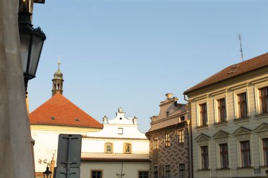 Historic buildings proudly standing in an urban setting, all under a bright and clear blue sky clipart