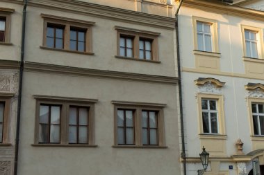 The facade of two historic buildings showcases intricate window designs, enhancing the urban landscape clipart