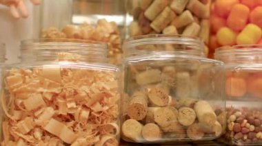 Ahşap talaşı ve mantarlarla dolu cam kavanozlar yaratıcı bir zanaat arka planına yerleştiriliyor.