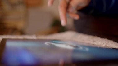 Tablet ekranına hafifçe dokunan bir elin yakın plan görüntüsü, desenli bir arka plana ayarlı