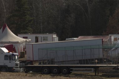 Açık arazide, çadırın hemen yanında park etmiş beyaz bir kamyon var. Doğal ortamda çarpıcı bir kontrastlık yaratıyor.