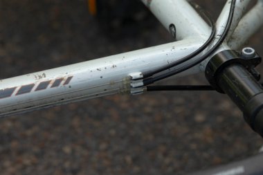 Bu, bir bisiklet iskeletini ve gidonunu gösteren detaylı bir yakın çekim görüntüsü, tasarımda yer alan işçiliği vurguluyor