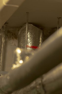 Bu, yüzeyinde belirgin bir kırmızı şerit bulunan bir boruya odaklanan yakın çekim görüntüsü, çevresine canlı bir kontrast sağlıyor.