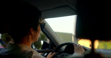 Bu canlı video modern sürüşleri gösteriyor. Birkaç tur, telefonunda birden fazla iş yapan bir kadın ve camdan dışarı bakan bir adam.