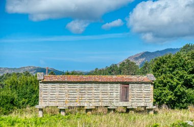 Horreos in Louredo in the municipality of Carnota, in the province of La Corua.Galicia, Spain. clipart