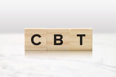 Three wooden tiles spelling CBT against a classy white marble background. clipart