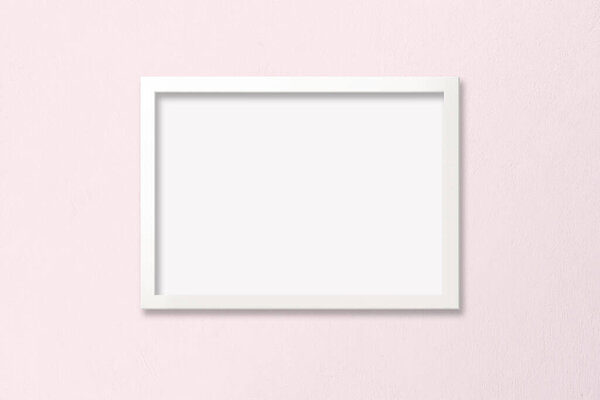 A4 white horizontal frame with empty poster against a baby pink background. Includes clipping path to make it easy to add your design to the frame.