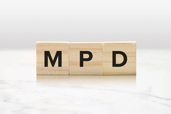 stock image Three wooden tiles spelling MPD against a classy white marble background.