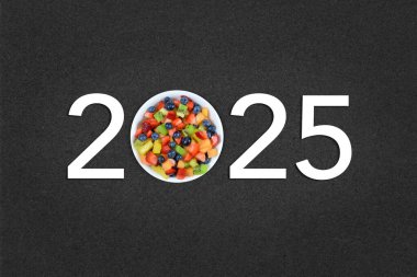 2025 New Year concept with a bowl of healthy fresh fruit clipart