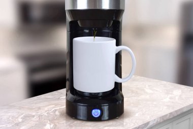 Close-up of kitchen coffee maker in white and black. Ideal for backgrounds, banners, and editorial use.