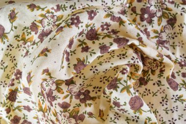 Close-up of white and brown floral fabric. Ideal for backgrounds, banners, and editorial use.