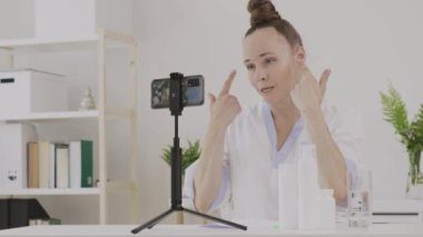 Female cosmetologist is giving online consultation. 