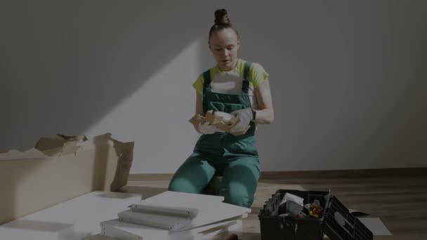 Young Female Assembling Piece Furniture High Quality Footage — Stockvideo