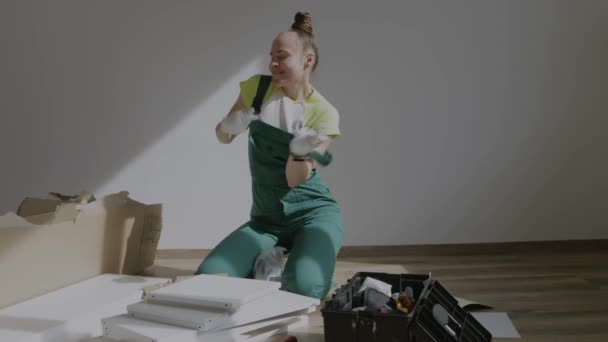 Young Female Assembling Piece Furniture High Quality Footage — Wideo stockowe