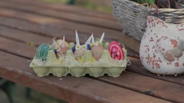 Decorated Easter eggs on the wooden table outdoor. High quality 4k footage