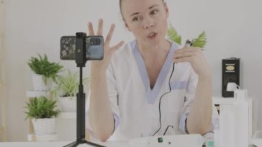 Female cosmetologist is giving online consultation. 