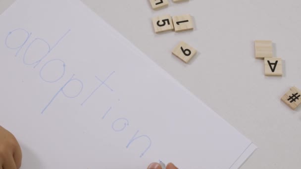Υιοθέτηση Λέξεων Γραμμένη Από Ένα Παιδί Ένα Χαρτί Υψηλής Ποιότητας — Αρχείο Βίντεο