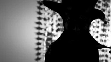 Person in the carnival mask of harlequin in the darkness. High quality 4k footage