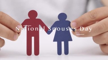 Paper cut out of female and male in the hands of a child. National Spouses Day