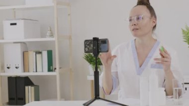 Female cosmetologist is giving online consultation. 