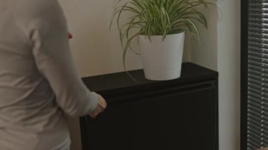 Female is throwing the rubbish in waste bin cupboard. High quality 4k footage