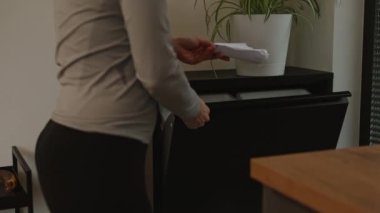Female is throwing the rubbish in waste bin cupboard. High quality 4k footage
