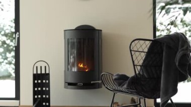 Metal armchair close to the real chimney. High quality 4k footage