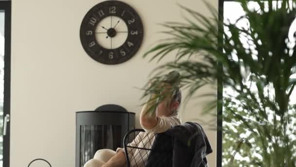 Stressed Female Sits Armchair Close Real Chimney High Quality Footage — Vídeo de Stock