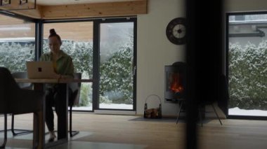 Young female is working at computer sitting at the table. High quality 4k footage