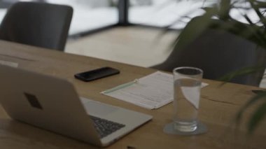 Family allowance form Familienbeihilfe in German language on the table.Young female is getting seated at the table. High quality 4k footage