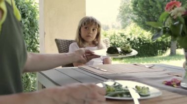 Girl of 7 years old has broccoli as a lunch. High quality 4k footage