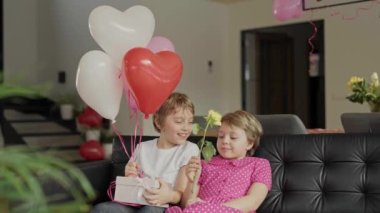 Boy and girl are in the decorated room for Valentines Day. High quality 4k footage