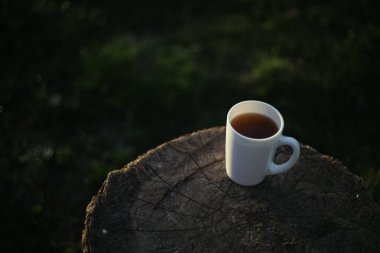 Bir fincan kahve, ahşap tezgahta çay.