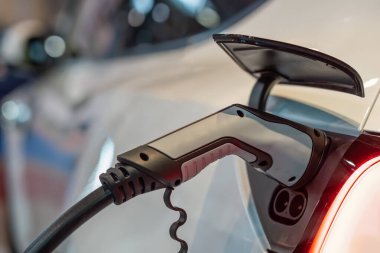 Elektrikli araba (EV) kabloyla prizde şarj oluyor.