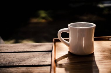 Coffee cup on the terrace seat. Shooting Location: Kamakura City, Kanagawa Prefecture