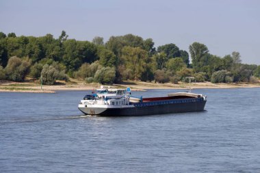 Güneşli bir yaz gününde Ren nehrinde kargo botları, uzun hava akımından dolayı düşük su koşulları. Düsseldorf, Kuzey Ren-Vestfalya, Almanya - 2 Eylül 2022