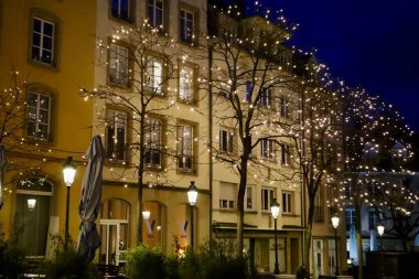 Christmas decorations on trees in Place de Clairefontaine and Winter lights festival. Luxembourg, Luxembourg - December 27, 2022