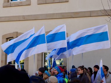 Rally in support of Ukraine on one year anniversary since the invasion. Group of new alternative Russian peace flags. Luxembourg, Luxembourg - February 25, 2023