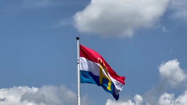 Luxembourg flag with monogram H and crown, flown to celebrate National day and Grand Dukes Henry official birthday. Luxembourg, Luxembourg - June 23, 2022