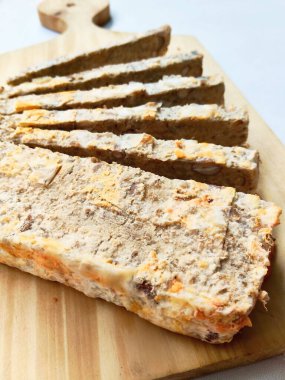 Geleneksel Endonezya mayalanmış dikdörtgen somunu, uzun atıştırmalık çubuklar halinde dilimlenmiş. Batı Java bölgesinden eşsiz, lezzetli ve fındıklı bir lezzet, ahşap üzerinde sunuluyor..