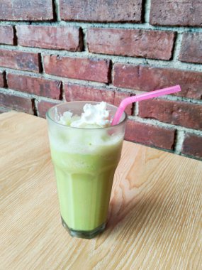 Enjoying a Delicious Summer Drink, Vibrant Matcha Beverage with Sweet Topping