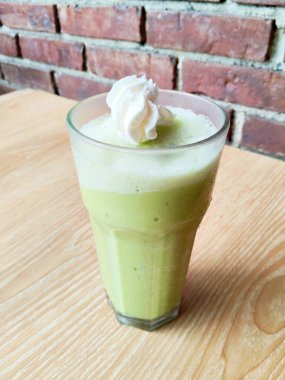 a glass of matcha green tea on table