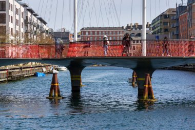 COPENHAGEN, DENMARK - MAY 1 2023: The Circle Bridge, Cirkelbroen, resembles a ship on the harbour of Christianshavn on May 1, 2023 in Copenhagen, Denmark. clipart