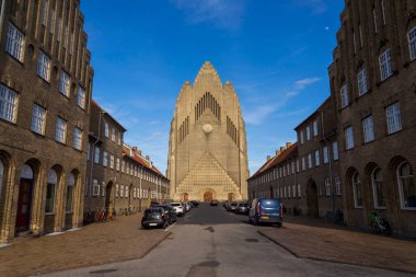 COPENHAGEN, DENMARK - APRIL 30 2023: People in front of the Grundtvigs church in the Bispebjerg district on April 30, 2023 in Copenhagen, Denmark. clipart