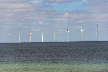 White turbines of Middelgrunden wind farm outside Copenhagen, Denmark, sustainable renewable electricity concept clipart