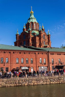 Cityscape with Eastern Orhodox Uspenski cathedral, Kauppatori in Etelasatama south harbour on July 6, 2024 in Helsinki, Finland. clipart